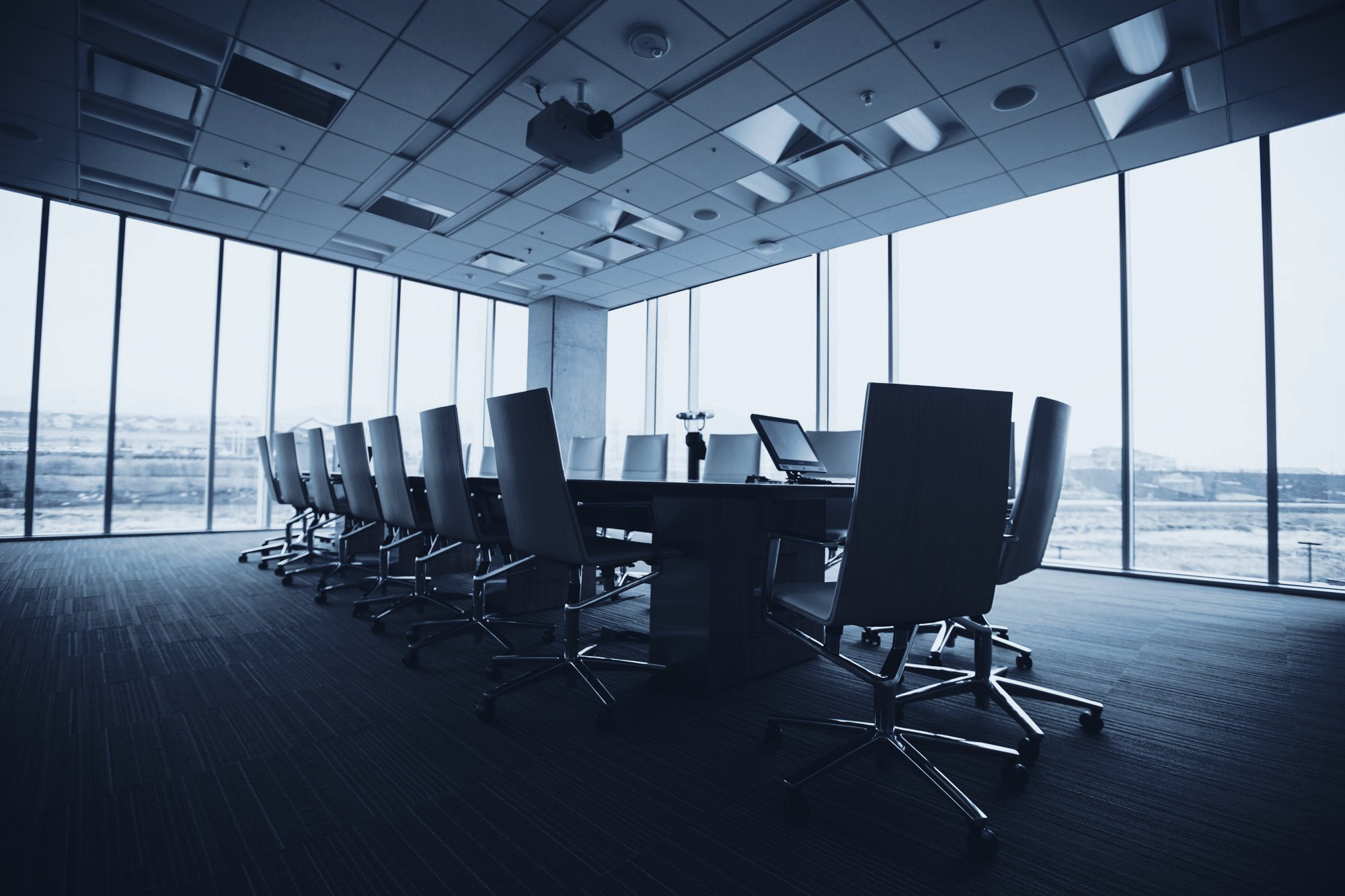 An empty boardroom with floor-to-ceiling windows
